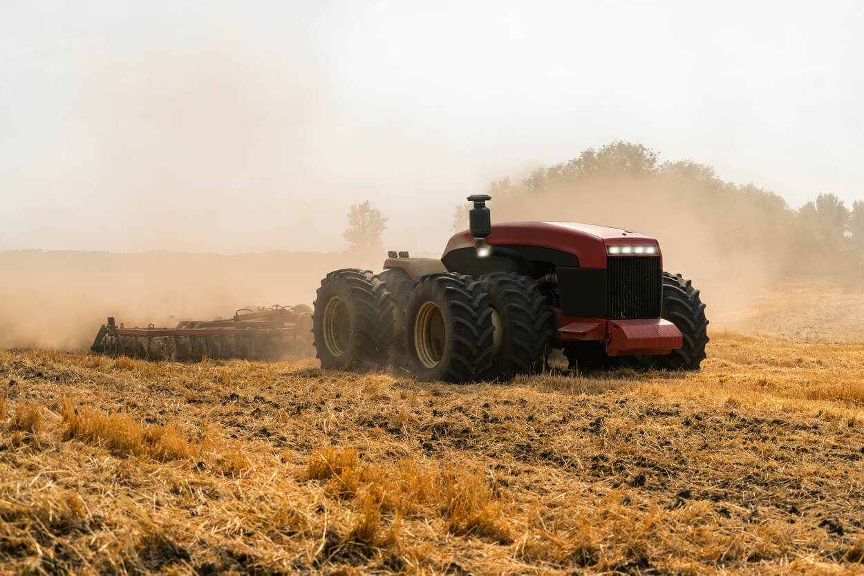 Tractor zonder bestuurder rijdt over een landbouwgrond